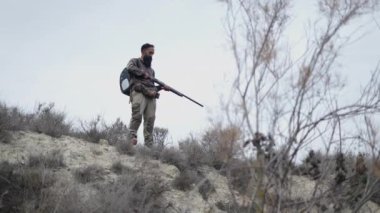 Sakallı bir avcı atış pozisyonunda - 4K Yatay video