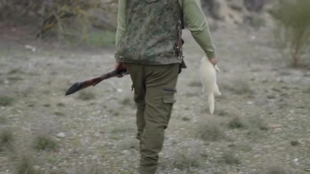 Unrecognizable Hunter Carrying White Ferret Horizontal Video — Stock Video
