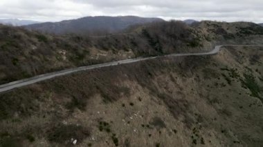 Drone, kamp yapan bir motosikletçiyle bir dağı yakalıyor - 4K Yatay Video