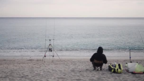 Front Sea Fisherman Awaits Fish Bite Horizontal Video — стоковое видео