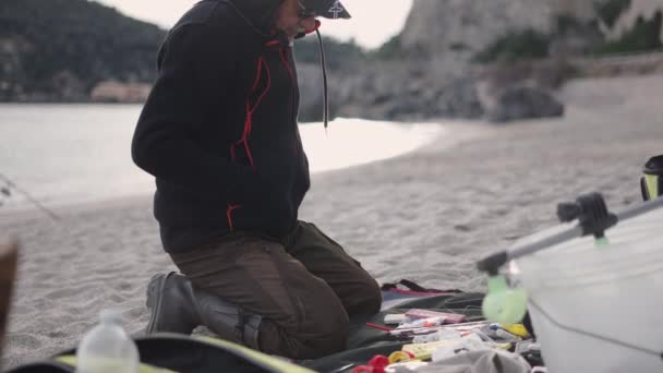 Fisherman Playing Fishing Accessories Horizontal Video — Stock Video