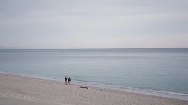 Distance Two Fishermen Talk Sand Horizontal Video — Stock Video
