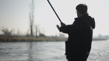 Tanınmayan bir balıkçı oltasının ipini çözer - 4K Yatay