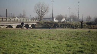 Uzakta iki adam balık tutuyor - 4K Yatay