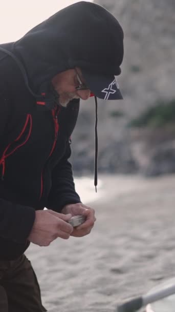 Beach Fisherman Plays Fishing Accessories Fullhd Vertical Video — Stock Video