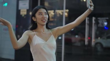 Asyalı etkileyicisi akıllı telefonunda bir şey gösteriyor - 4K Yatay Video