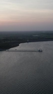 İHA, Long Thanh Gölü Vietnam 'da uzun bir gece iskeletiyle büyük bir gölün üzerinde uçuyor.