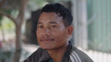 Vietnam 'da kameraya el sallayan ve gülümseyen Asyalı genç bir adamın portresi - 4K Yatay