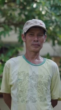 Kameraya bakan zayıf Asyalı Vietnamlı genç bir adamın yarım boy portresi.