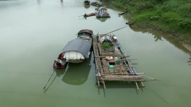 Çiftçiler, Vietnam 'ın kırsal kesiminde, nehrin kıyısındaki küçük kulübelerde yaşarlar - 4K Yatay