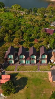 Beautiful aerial perspective of a hotel resort surrounded by lush green trees and mountains