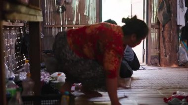 Elderly couple preparing ingredients and cooking food together in a traditional rustic kitchen in a rural house - 4K Horizontal