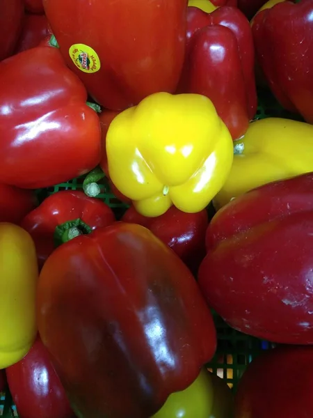 close up of red and yellow peppers