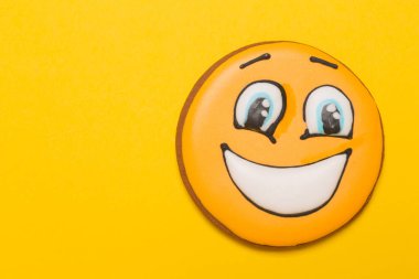 cookie smile and emotions, open mouth, baby gingerbread, on yellow background