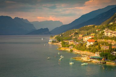 Above idyllic Lake Garda in Malcesine at dramatic sunset, northern Italian alps