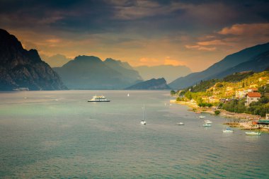 Above idyllic Lake Garda in Malcesine at dramatic sunset, northern Italian alps