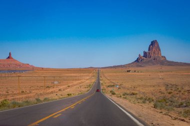Highway Road U.S. Highway 163 and Monument Valley at sunset, Arizona, United States clipart