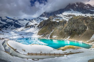 Alp zümrüt gölü ve baharda dağ yolu, Gran Paradiso Alpleri, İtalya, Fransa sınırına yakın.