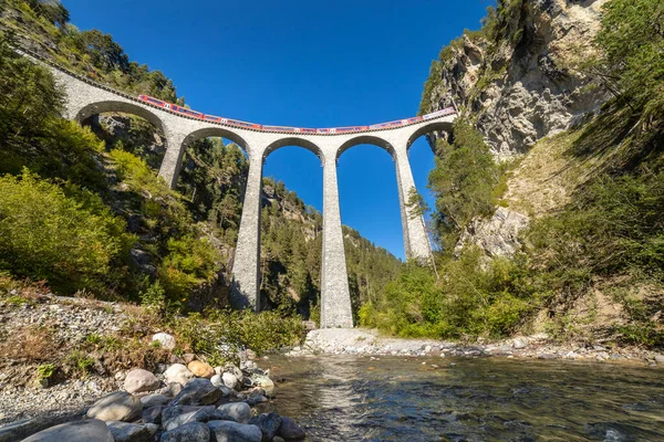 stock image Swiss train over Landwasser Viaduct bridge in the alps, Graubunden valley, Switzerland