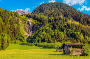 Alpine farm in Green Stubai valley near Innsbruck at sunset, Tyrol, Austria clipart