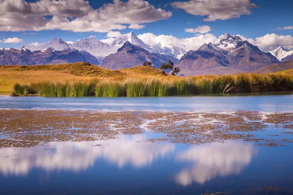Turquoise laguna Wilcacocha with mirrored reflection in Cordillera Blanca, snowcapped Andes, Ancash, Peru
