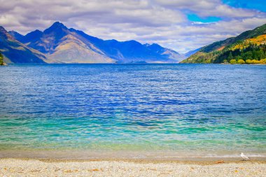 Lake Wakatipu coatline in south New Zealand at sunset, near Queenstown