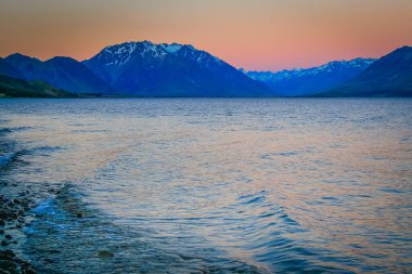 Blue Lake Tekapo at peaceful evening, New Zealand South island idyllic landscape