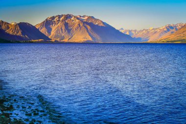 Blue Lake Tekapo at peaceful evening, New Zealand South island idyllic landscape