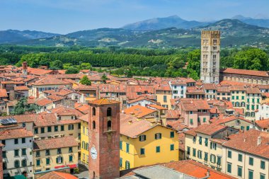 Historical medieval town Lucca with old buildings and mountain range, Tuscany, Italy