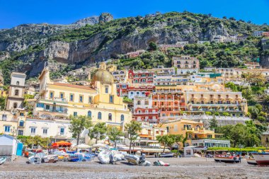 Idyllic Positano city cliffs and marina with boats and yacht, amalfi coast, Italy