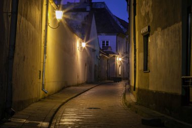 Vilnius old town street illuminated at night, Lithuania, Baltic countries