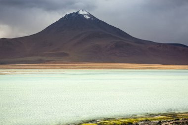 Salt lake reflection and idyllic volcanic landscape at Sunset, Atacama desert, Chile border with Bolivia