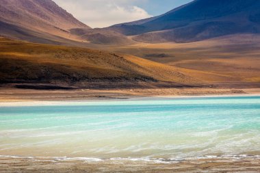 Salt lake reflection and idyllic volcanic landscape at Sunset, Atacama desert, Chile border with Bolivia