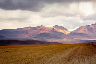 Dirt Road in Peaceful Moon Valley dramatic landscape at Sunset, Atacama Desert, Chile