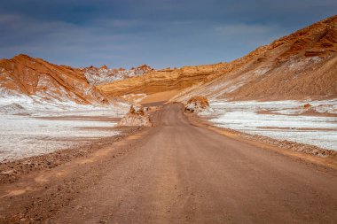 Dirt Road in Peaceful Moon Valley dramatic landscape at Sunset, Atacama Desert, Chile