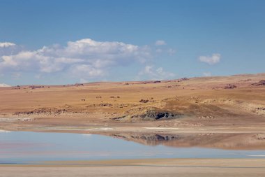 Salt lake reflection and idyllic volcanic landscape at Sunset, Atacama desert, Chile border with Bolivia
