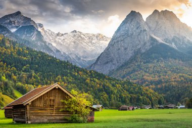 Bavarian alps and rustic farm barns, Garmisch Partenkirchen, Zugspitze massif, Bavaria, Germany