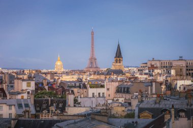 Eiffel Tower and french roofs architecture from above at sunrise from quartier latin, Paris, France