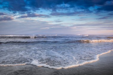 Secluded beach in Torres at dramatic evening, Rio Grande do Sul, Southern Brazil