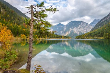 Lake reflection in Bavarian alps at golden autumn, Karwendel mountains, Bavaria, Germany border with Austria