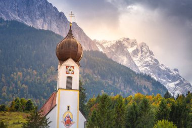 Grainau Church at golden autumn sunrise and Zugspitze massif, Bavarian alps , Germany clipart