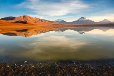 Salt lake Lejia reflection and idyllic volcanic landscape at Sunset, Atacama desert, Chile