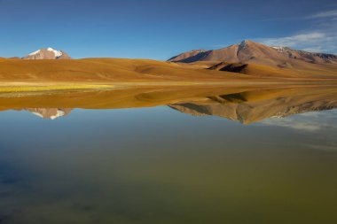 Salt lake Lejia reflection and idyllic volcanic landscape at Sunset, Atacama desert, Chile