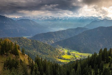 Bavarian alps and valleys from above at dramatic autumn sky near Garmisch, Germany, border with Austria Tyrol