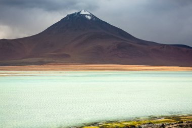Salt lake reflection and idyllic volcanic landscape at Sunset, Atacama desert, Chile border with Bolivia