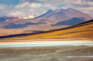 Salt lake reflection and idyllic volcanic landscape at Sunset, Atacama desert, Chile border with Bolivia