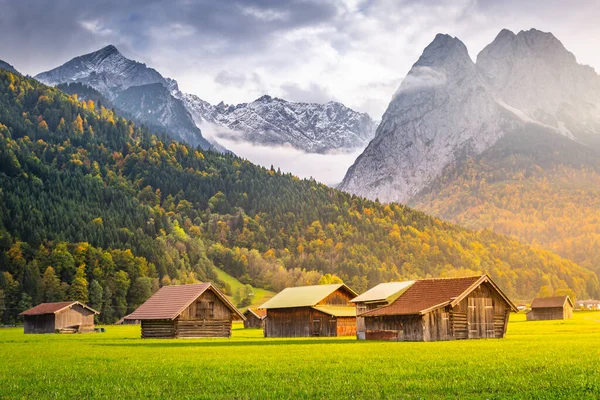 Bavarian alps and rustic farm barns, Garmisch Partenkirchen, Zugspitze massif, Bavaria, Germany