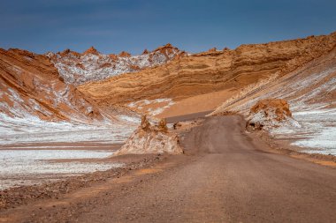Dirt Road in Peaceful Moon Valley dramatic landscape at Sunset, Atacama Desert, Chile