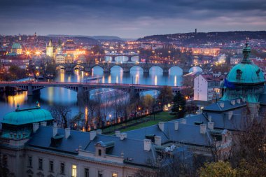 Panoramic view over the cityscape of Prague and Vltava river at dramatic evening, Czech Republic