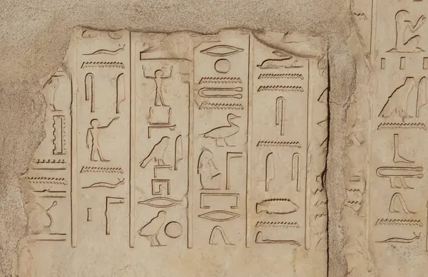 Ancient egyptian hieroglyphs carved at Satet temple in Aswan, Egypt